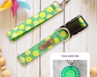 May include: A green fabric collar and matching keychain featuring a yellow tennis ball pattern. The collar has a black plastic buckle, a metal D-ring, and a brown brand tag reading Citrine Sunrise. An inset shows a round green tag reading PLEASE THROW THE DAMN BALL.