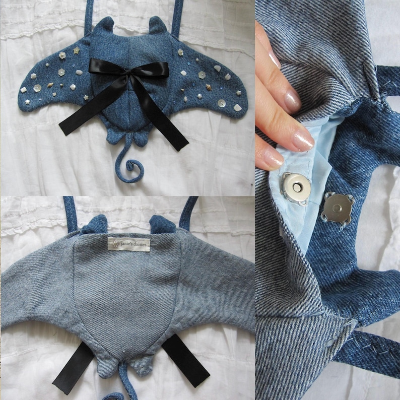 May include: A blue denim manta ray bag with a black ribbon bow and white pearl embellishments. The bag has a magnetic closure and a small tag that says "Sew Much Cuteness".