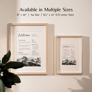 K&ouml;nnte beinhalten: Zwei gerahmte Willkommensschilder mit schwarzem und wei&szlig;em Text und einem Bild einer Bergkette. Die Schilder sind in den Gr&ouml;&szlig;en 8x10 Zoll, A4 und 8,5x11 Zoll erh&auml;ltlich. Der Text auf den Schildern lautet "Willkommen", "Hausregeln", "WLAN", "Check-out", "Kontakt" und "Bewertungen".