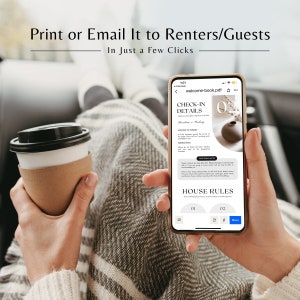 May include: A person's hand holding a smartphone displaying a welcome book for renters or guests. The screen shows a check-in details section with information about the location, parking, and house rules. The phone is on a gray blanket.