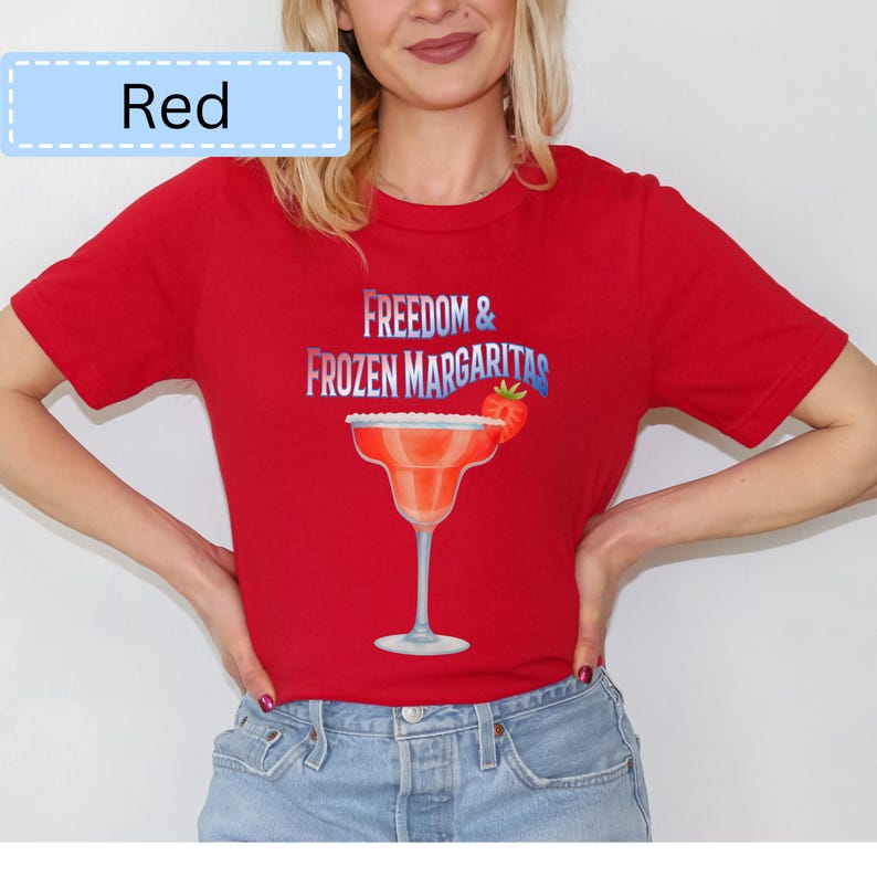 May include: Red t-shirt with the text "Freedom & Frozen Margaritas" and a margarita glass graphic. The margarita glass has a strawberry garnish. The word "Red" is in a light blue box in the upper left corner.
