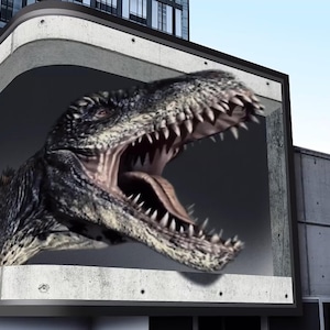 May include: A large, gray dinosaur head with sharp teeth and an open mouth is depicted on a billboard. The dinosaur is positioned as if it is breaking through the billboard.