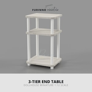May include: A three-tier end table dollhouse miniature. The table has a light wood grain finish on the shelves and white supports. The table is 4 inches tall, 2.5 inches wide, and 2.5 inches deep.