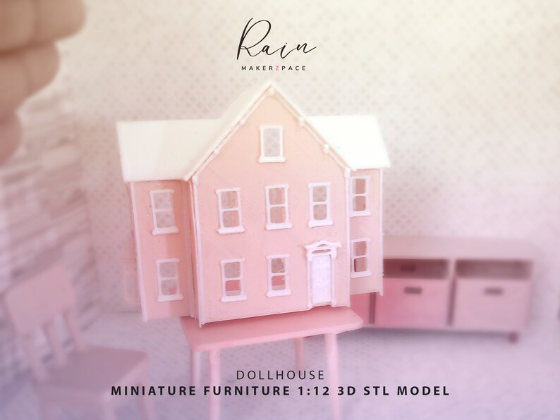 May include: A pink dollhouse miniature with a white roof and window frames. The dollhouse is on a small pink table. The text "Rain MAKER2PACE" is at the top, and "DOLLHOUSE MINIATURE FURNITURE 1:12 3D STL MODEL" is at the bottom.