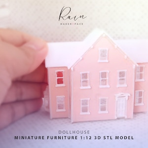 May include: A miniature pink dollhouse with a white roof and trim is held by a hand. The dollhouse has multiple windows and a front door. Text on the image reads "Rain MAKERZPACE" and "DOLLHOUSE MINIATURE FURNITURE 1:12 3D STL MODEL."