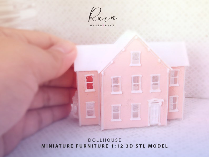 May include: A miniature pink dollhouse with a white roof and trim is held by a hand. The dollhouse has multiple windows and a front door. Text on the image reads "Rain MAKERZPACE" and "DOLLHOUSE MINIATURE FURNITURE 1:12 3D STL MODEL."