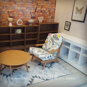 May include: Miniature living room scene with a round coffee table, a wooden armchair with a floral cushion, and a patterned rug. The scene includes shelves, decorative vases, and framed artwork. The text on the image reads "SOFA BACK TABLE MINIATURE FURNITURE 1:12 3D STL MODEL."