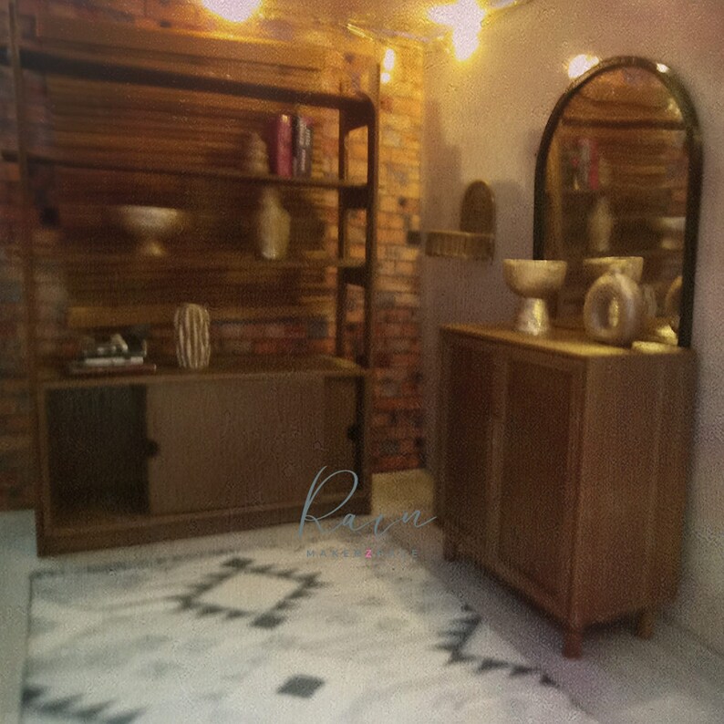 May include: A wooden cabinet with two doors and a shelf, a wooden shelf unit with four shelves, a white and gray patterned rug, and a large arched mirror with a gold frame. The cabinet and shelf unit are both in a rustic style.