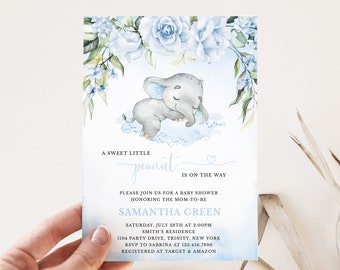 May include: A blue and white baby shower invitation with a watercolor illustration of a sleeping elephant and floral accents. The text reads "A sweet little peanut is on the way".