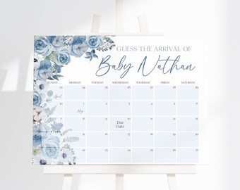 May include: A blue and white floral baby shower game with a calendar for guests to guess the arrival date of Baby Nathan. The calendar is for the months of April and May.