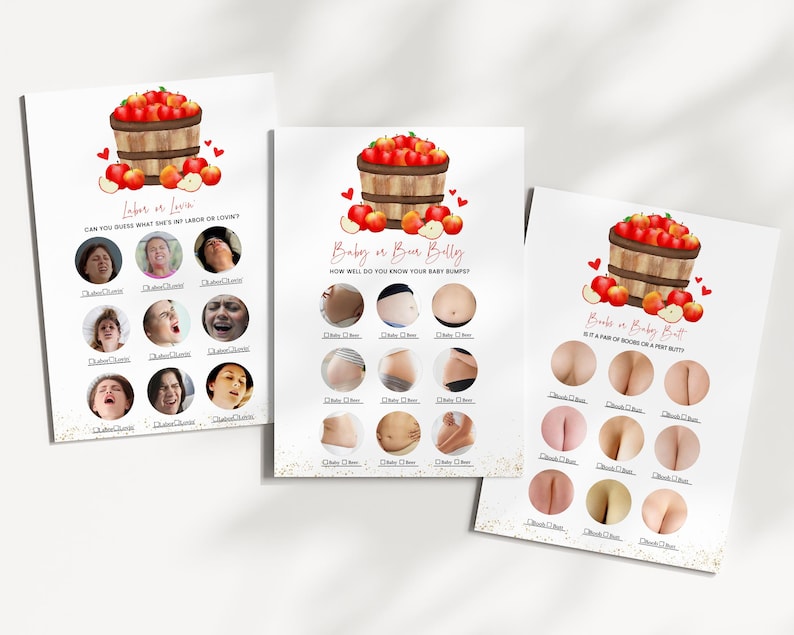 May include: Three white cards with baby shower games. Each card features a watercolor illustration of a wooden basket overflowing with red apples. The games include "Labor or Love," "Baby or Beer Belly," and "Boobs or Baby Butt."