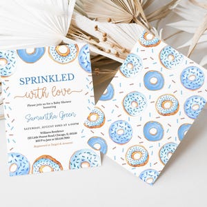 May include: A baby shower invitation with a blue and white donut pattern. The text reads "Sprinkled with love" and includes the name "Samantha Green".