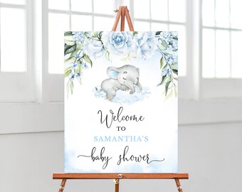 May include: A blue and white baby shower welcome sign featuring a watercolour illustration of a sleeping elephant and floral details. The sign reads "Welcome to Samantha's Baby Shower".