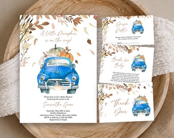 May include: A set of baby shower stationery featuring a blue vintage truck carrying pumpkins, surrounded by watercolor autumn leaves. The text includes A little Pumpkin is on the way, Diaper Raffle, Books for Baby, and Thank You with event details.