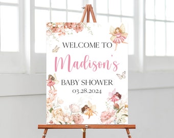 May include: A white welcome sign with pink floral designs and butterflies. The text reads "Welcome to Madison's Baby Shower 03.28.2024".