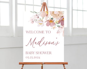 May include: Welcome to Madison's Baby Shower sign with a floral design featuring pink and white flowers on a white background. The date of the event is 03.23.2024.