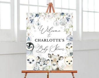 Peut inclure: Panneau de bienvenue pour une baby shower sur un chevalet. Le panneau affiche le texte "Welcome to Charlotte's Baby Shower". Le design comprend des illustrations à l'aquarelle d'animaux d'hiver et des éléments décoratifs dans des tons bleus et blancs doux.