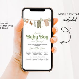 May include: A mobile invitation for a baby shower, displayed on a smartphone. The invitation features a green and beige color scheme with the text "A sweet Baby Boy is on the way!" and includes details for the event. Decorative elements include baby clothes.
