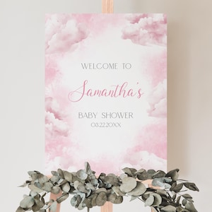 May include: Pink and white baby shower welcome sign with clouds and the text "Welcome to Samantha's Baby Shower 082220XX".