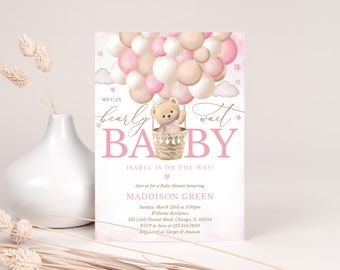 May include: A pink and gold baby shower invitation with a teddy bear in a hot air balloon made of pink and beige balloons. The text reads "We can barely wait BABY, Isabel is on the way!" and includes details for the baby shower.
