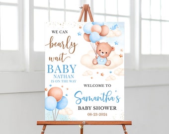May include: A welcome sign for a baby shower with a blue and brown teddy bear holding balloons. The sign says "We can barely wait Baby Nathan is on the way. Welcome to Samantha's Baby Shower 08-23-2024".