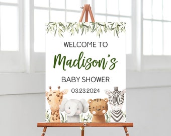 May include: A rectangular welcome sign for a baby shower featuring the text "WELCOME TO Madison's BABY SHOWER 03.23.2024". The design includes watercolor illustrations of a giraffe, elephant, tiger, and zebra, accented with green foliage at the top.