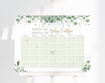 Puede incluir: Un cartel rectangular con una cuadrícula de calendario para adivinar la fecha de llegada de un bebé. El diseño incluye hojas de eucalipto verdes en la parte superior e inferior, con el texto GUESS THE ARRIVAL OF Baby Caitlyn, April, May y Due Date.