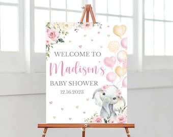 May include: A rectangular sign featuring the text WELCOME TO Madison's BABY SHOWER 12.16.2023. The design includes watercolor illustrations of pink roses, cream flowers, a gray baby elephant wearing a floral crown, and pink and gold balloons.