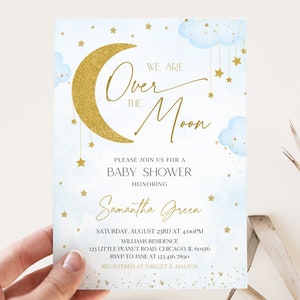May include: A baby shower invitation with a blue and gold colour scheme. The invitation features a crescent moon with gold glitter, clouds, and stars. The text reads "We are Over the Moon" and includes details about the shower, including the date, time, location, and RSVP information.