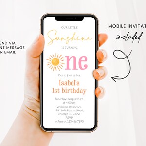 May include: A mobile phone screen displaying a birthday invitation for a one-year-old. The invitation features a sun graphic and the text "Our Little Sunshine is Turning One". The invitation includes the birthday girl's name, date, time, location, and RSVP information.