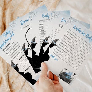 May include: Four blue and white Halloween-themed baby shower game cards with black silhouettes of witches and cauldrons. The cards include games like "Baby Predictions and Resemblance", "Draw", "Baby Wishes for Baby", and "Whose Baby Feature Baby Will Have Mark".