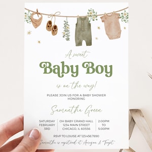 May include: Baby shower invitation with the text "A sweet Baby Boy is on the way!" in green. The invitation features watercolor illustrations of baby clothes and accessories hanging on a clothesline. The invitation is for Samantha Green.