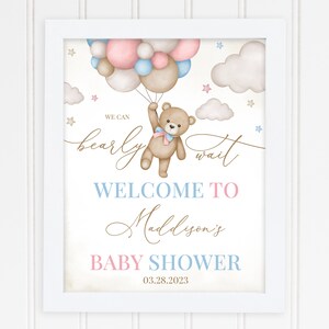 May include: A baby shower sign with a teddy bear holding balloons. The sign says "We can bearly wait" and "Welcome to Maddison's Baby Shower 03.28.2023".