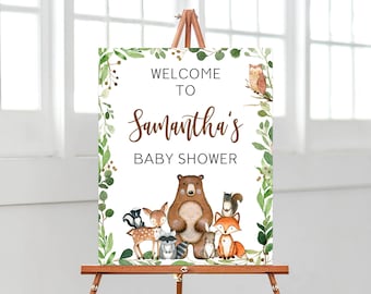 May include: Welcome to Samantha's Baby Shower sign with a woodland theme. The sign features a brown bear, a fox, a deer, a raccoon, a squirrel, and an owl surrounded by green leaves.