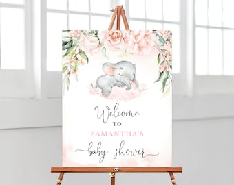 May include: A pink and green floral welcome sign with a watercolor illustration of a sleeping elephant. The sign reads "Welcome to Samantha's Baby Shower".