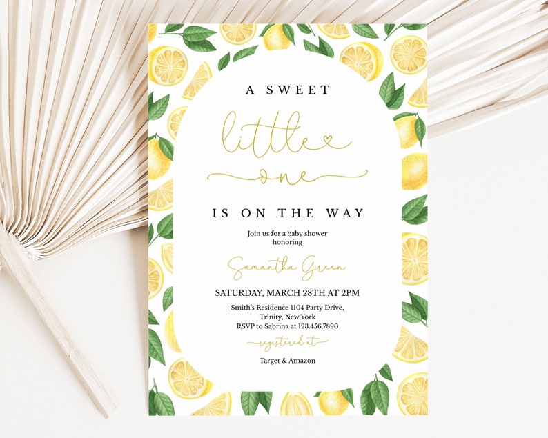 May include: A white baby shower invitation with a lemon theme. The invitation has a yellow and green border of lemons and leaves. The text reads "A Sweet Little One Is On The Way" and includes the date, time, and location of the shower.