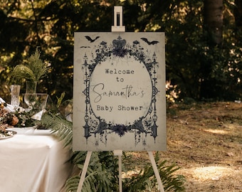 May include: A black and white welcome sign with a spooky gothic design. The sign says "Welcome to Samantha's Baby Shower".