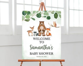 May include: Welcome to Samantha's Baby Shower sign featuring a watercolour illustration of a bear, deer, raccoon, fox, and owl on a green background. The text reads "Welcome to Samantha's Baby Shower March 23, 2021".