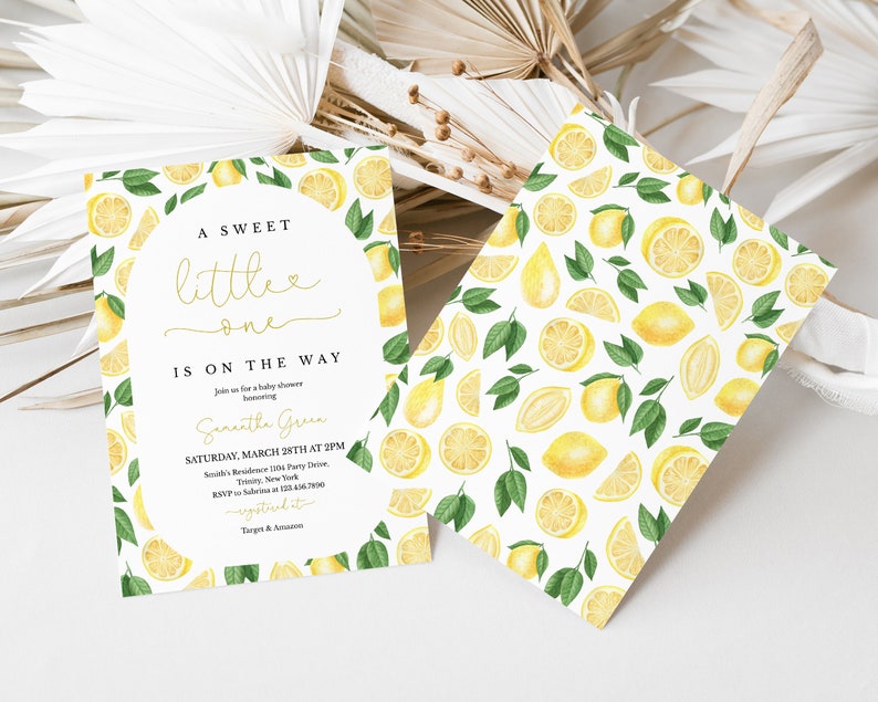 May include: A white baby shower invitation with a lemon theme. The invitation features a watercolour illustration of lemons and leaves. The text on the invitation reads "A Sweet Little One Is On The Way" and includes the date, time, and location of the shower.