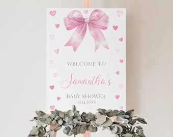 May include: Welcome to Samantha's Baby Shower sign with a pink watercolor bow and hearts. The date is 02.14.20XX.