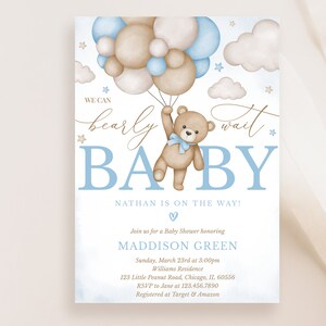 May include: A baby shower invitation with a blue and brown colour scheme. The invitation features a teddy bear holding onto blue and brown balloons. The text on the invitation reads "We can barely wait Baby Nathan is on the way!" and includes the date, time, and location of the shower.