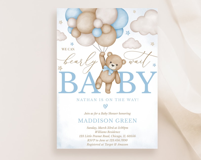 May include: A baby shower invitation with a blue and brown colour scheme. The invitation features a teddy bear holding onto blue and brown balloons. The text on the invitation reads "We can barely wait Baby Nathan is on the way!" and includes the date, time, and location of the shower.