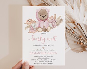 May include: Baby shower invitation featuring a watercolor illustration of a teddy bear in a pink hooded outfit, surrounded by floral elements. The text reads "We can bearly wait" and announces a baby shower for Samantha Green.