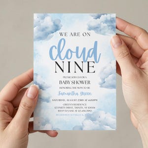 May include: A rectangular baby shower invitation card featuring a watercolour sky background with fluffy blue and white clouds. The text reads: WE ARE ON cloud NINE PLEASE JOIN US FOR A BABY SHOWER HONOURING THE MUM-TO-BE Samantha Green SATURDAY, AUGUST 23RD AT 4:00PM.