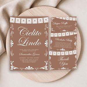 May include: A set of brown baby shower stationery featuring white papel picado banner graphics and elegant script text. The main invitation reads Cielito Lindo, Samantha Green, and event details. Includes a diaper raffle card, book request, and thank you card.