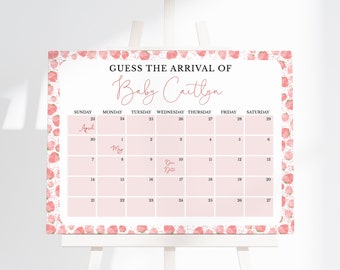 Puede incluir: Un calendario rosa y blanco con un patrón de fresas. El calendario es para los meses de abril y mayo. El texto "Adivina la llegada de Baby Caitlyn" está en la parte superior del calendario.