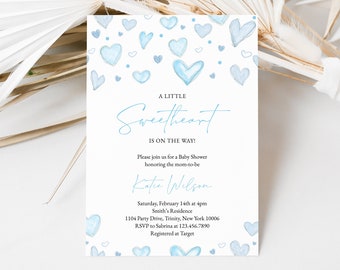 May include: A baby shower invitation with a blue watercolor heart design. The text reads "A Little Sweetheart is on the Way!" and includes details about the event, including the date, time, location, and RSVP information.
