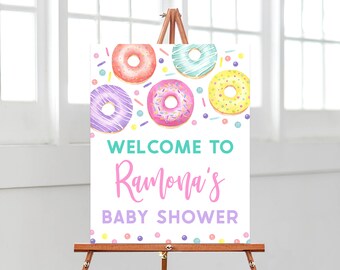 Puede incluir: Bienvenido al Baby Shower de Ramona con temática de donas. El cartel tiene un fondo blanco con donas y chispas de colores.