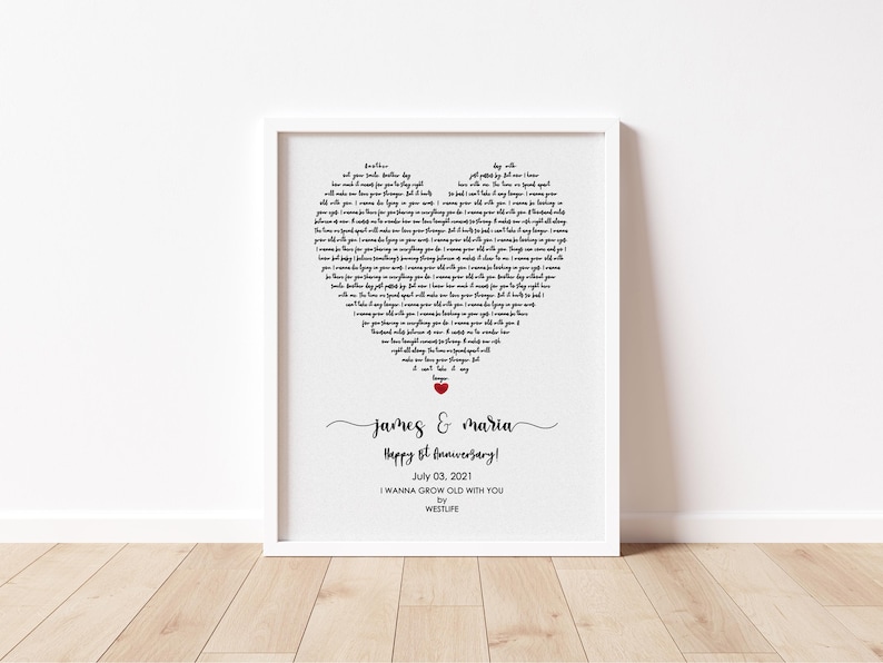 May include: A framed print with a white border features a heart-shaped design composed of song lyrics. The names "James & Maria" are written in cursive, with "Happy 8th Anniversary!" below. The date "July 03, 2021" is also included.