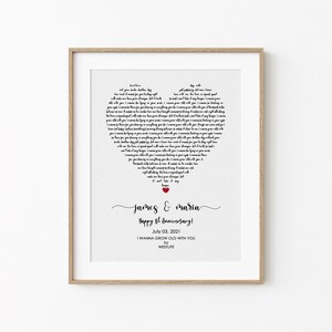 May include: A framed print with a heart-shaped design made of song lyrics. The names "James & Maria" are written in cursive below the heart, with "Happy 6th Anniversary!" and the date July 03, 2021. The song title is "I Wanna Grow Old With You."